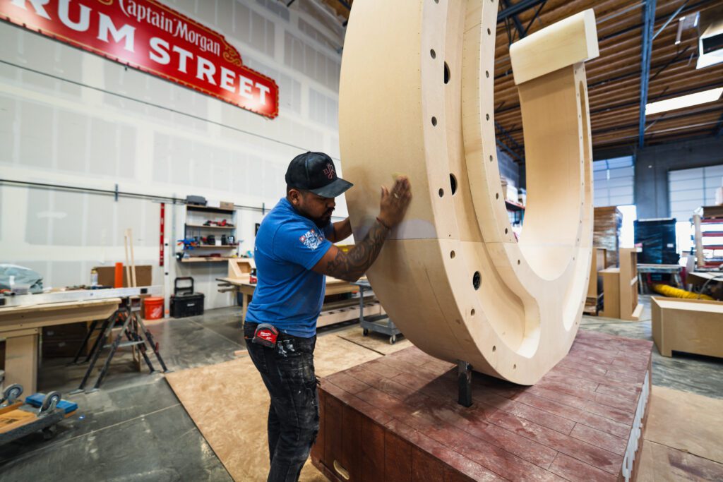 Worker screwing part of wooden structure