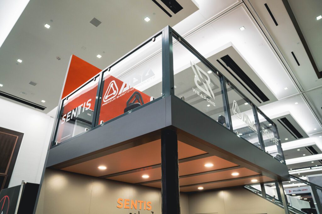View of tall exhibit booth with signage and sponsorship