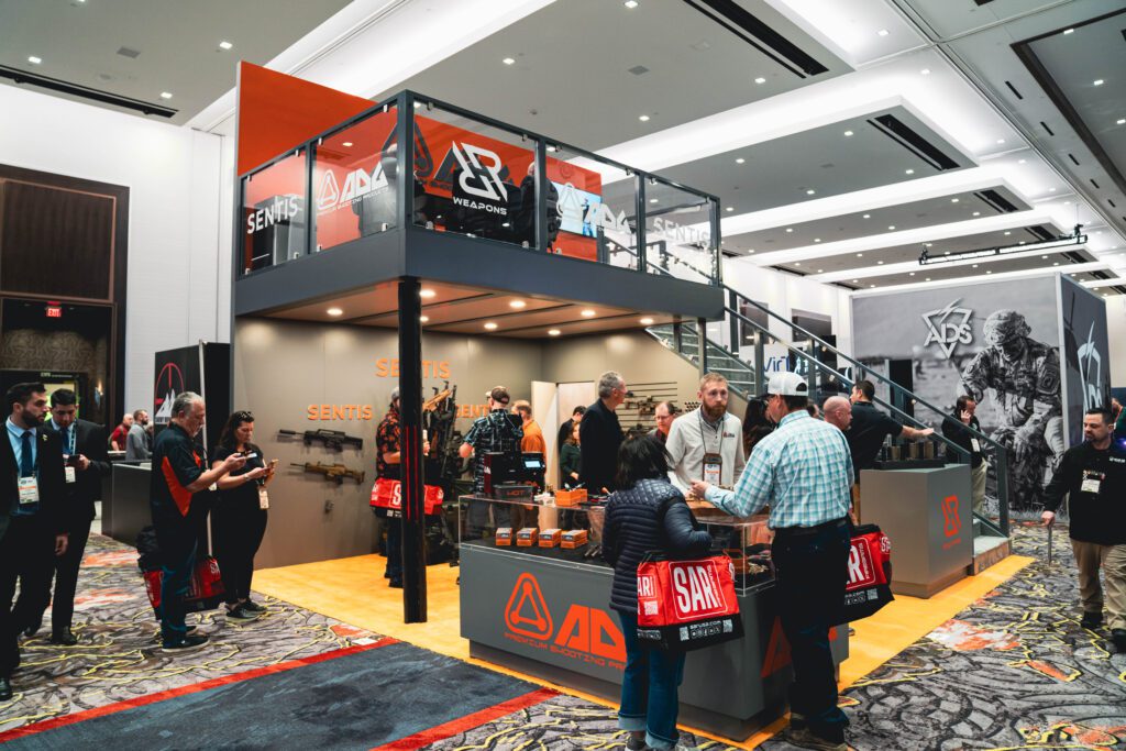 Attendees networking at trade show booth