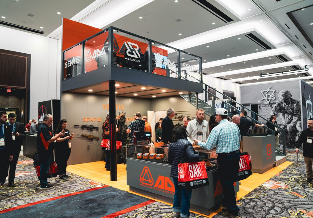 Trade show booth filled with attendees