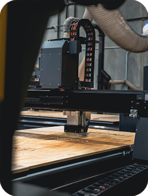 CNC router cutting material in fabrication shop