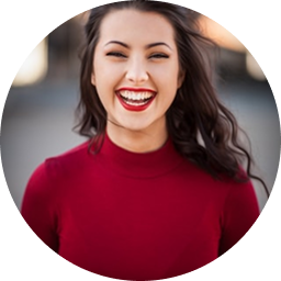 Woman smiling in red sweater headshot