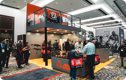 Trade show booth with orange and black branding
