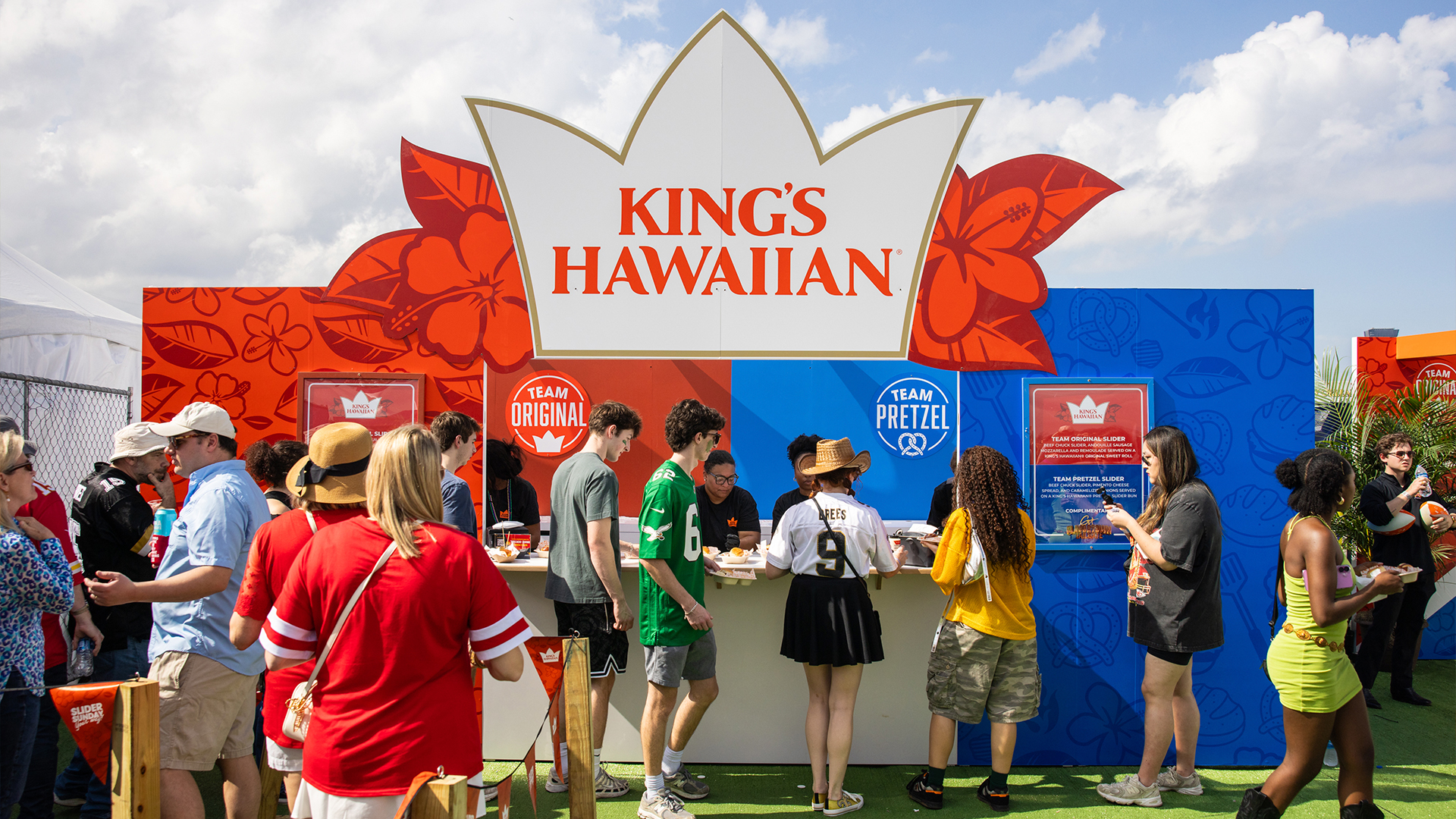Crowd gathers at a colorful King’s Hawaiian booth featuring “Team Original” and “Team Pretzel” sections at an outdoor event.
