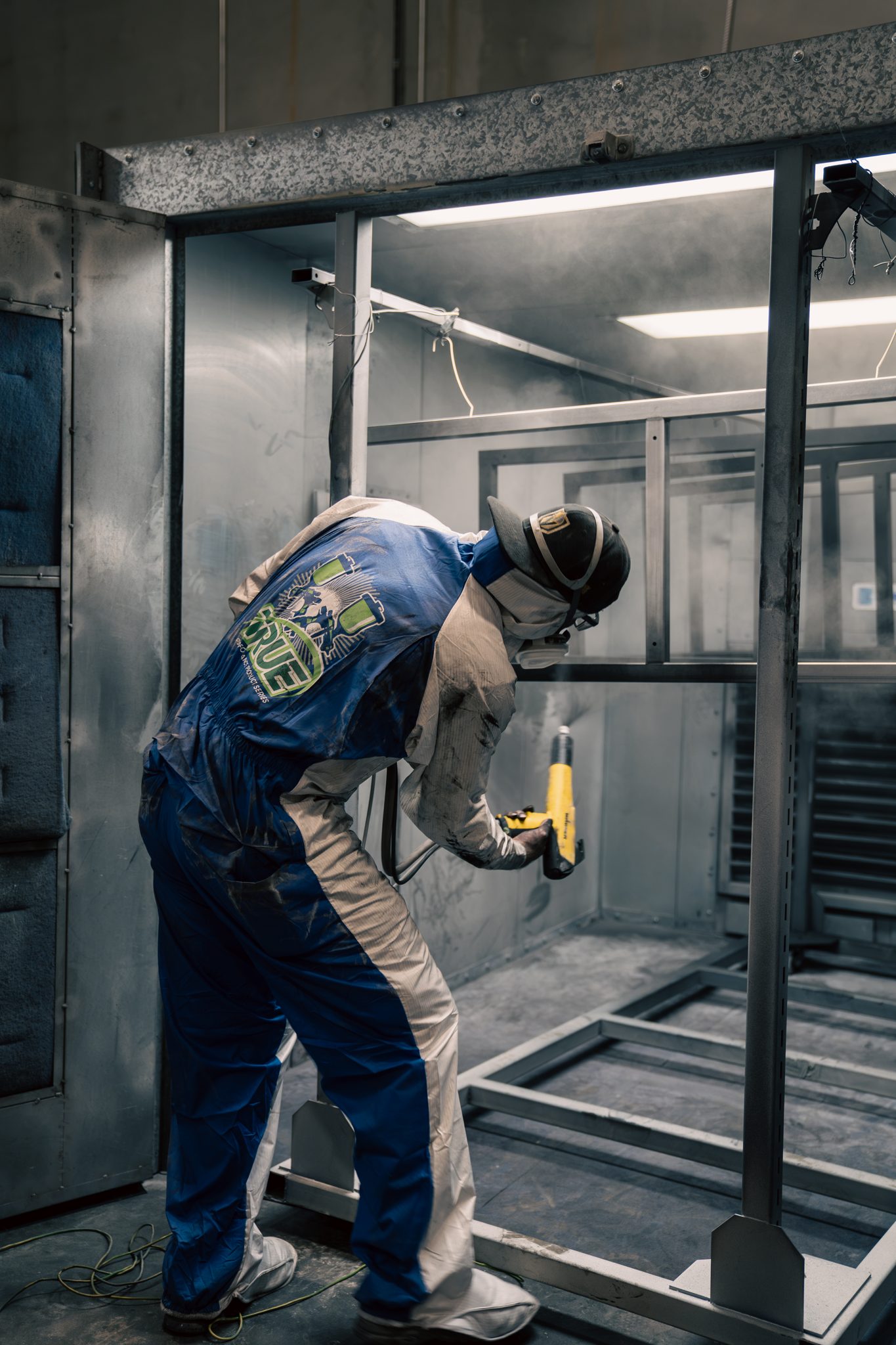 Full coverage powder application on a fabricated steel structure