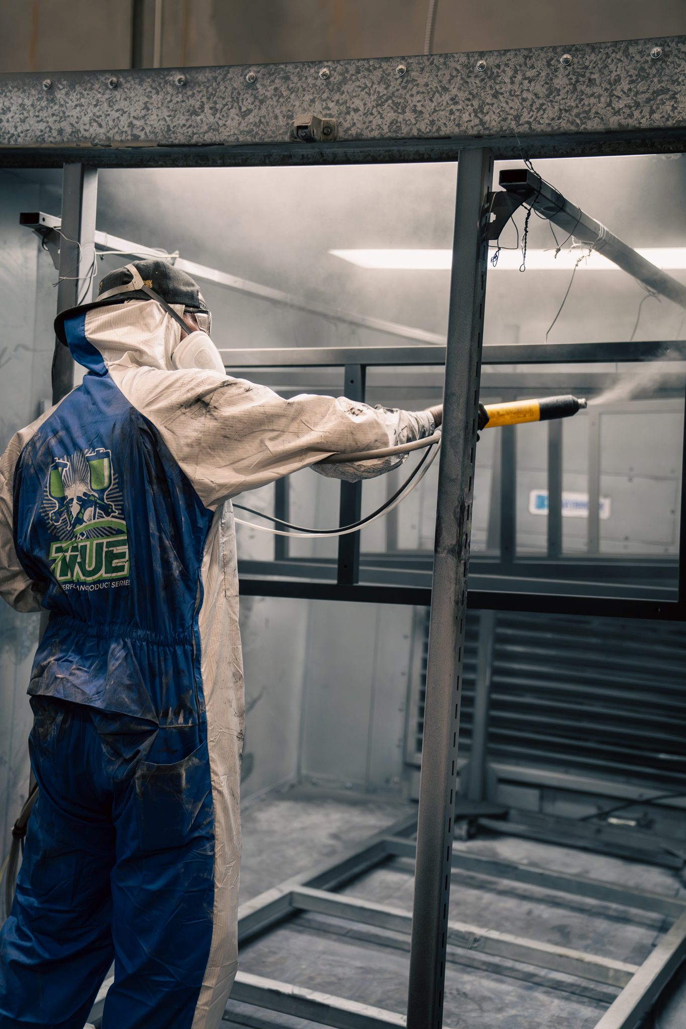 Coating pass on a custom steel fixture in the booth