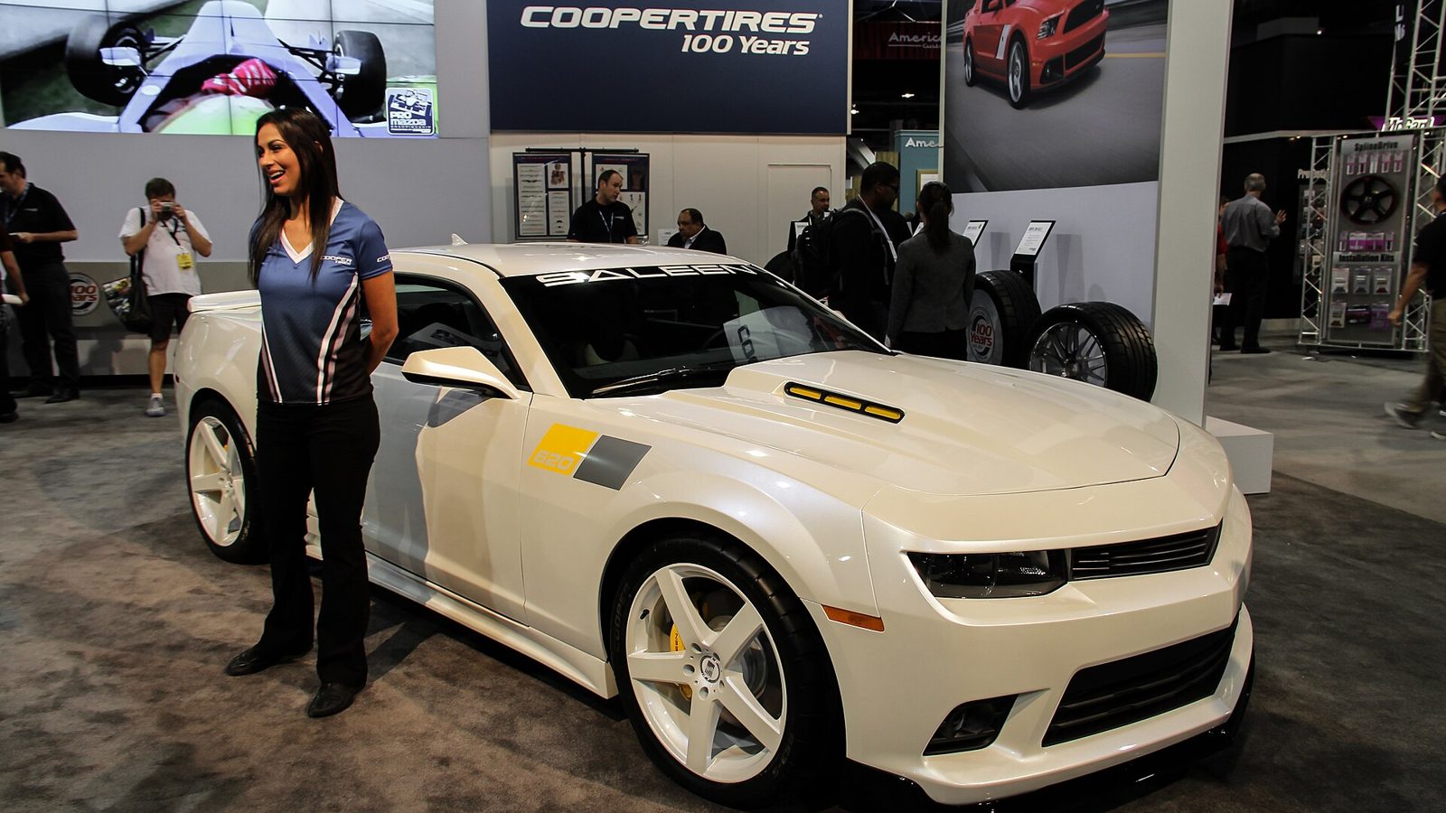 Inline SEMA Show booth with a display vehicle and branded backwall