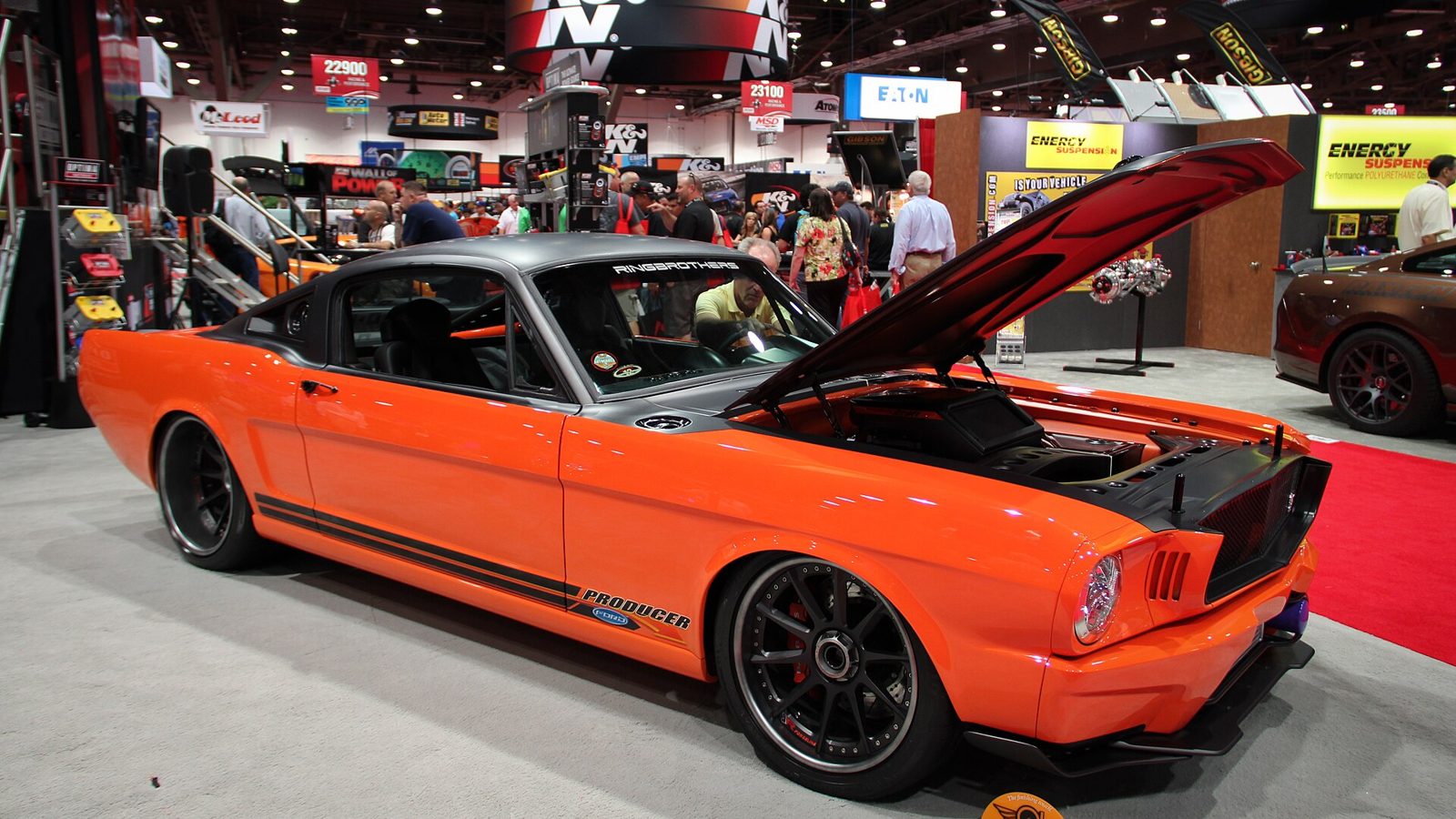 SEMA Show floor inside the Las Vegas Convention Center with exhibitor booths and crowds